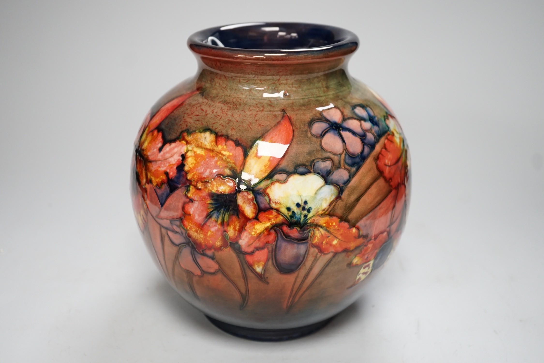 A Moorcroft flambé ‘orchid’ globe shaped vase, 21cm